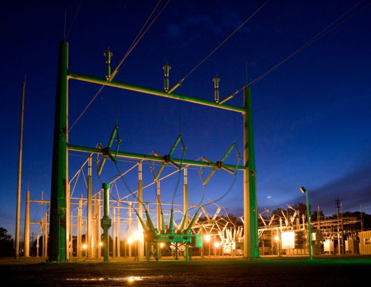 green and grey transmission tower during nighttime